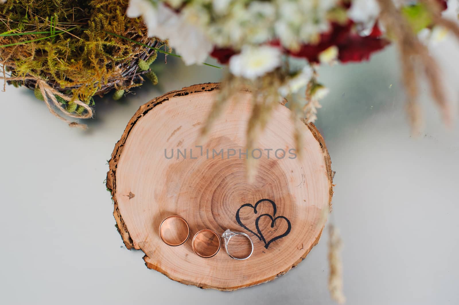 wedding rings on a wooden stump in a rustic style.