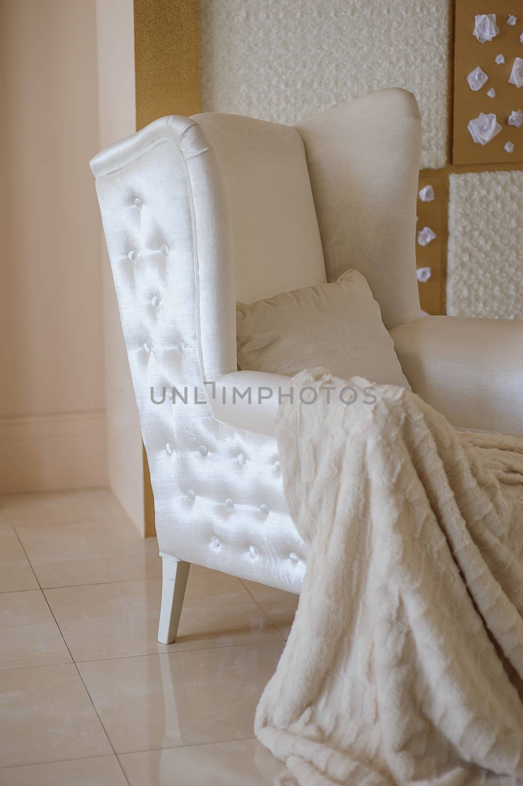 white chair with a blanket in the studio.