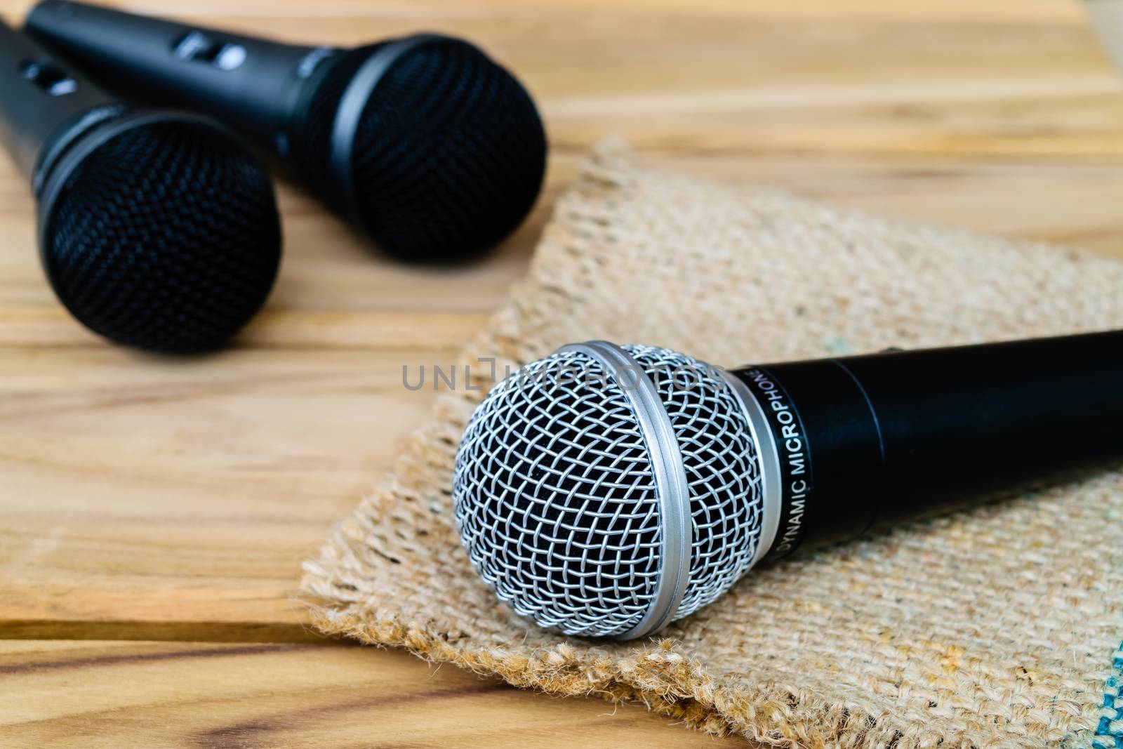 microphone on sack wooden background