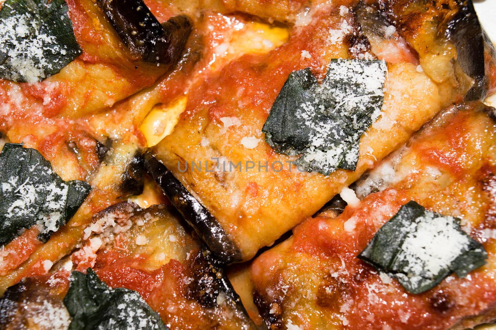 rolled slices of eggplant, stuffed with ham and cheese, served with tomato basil and grated Parmesan cheese and baked