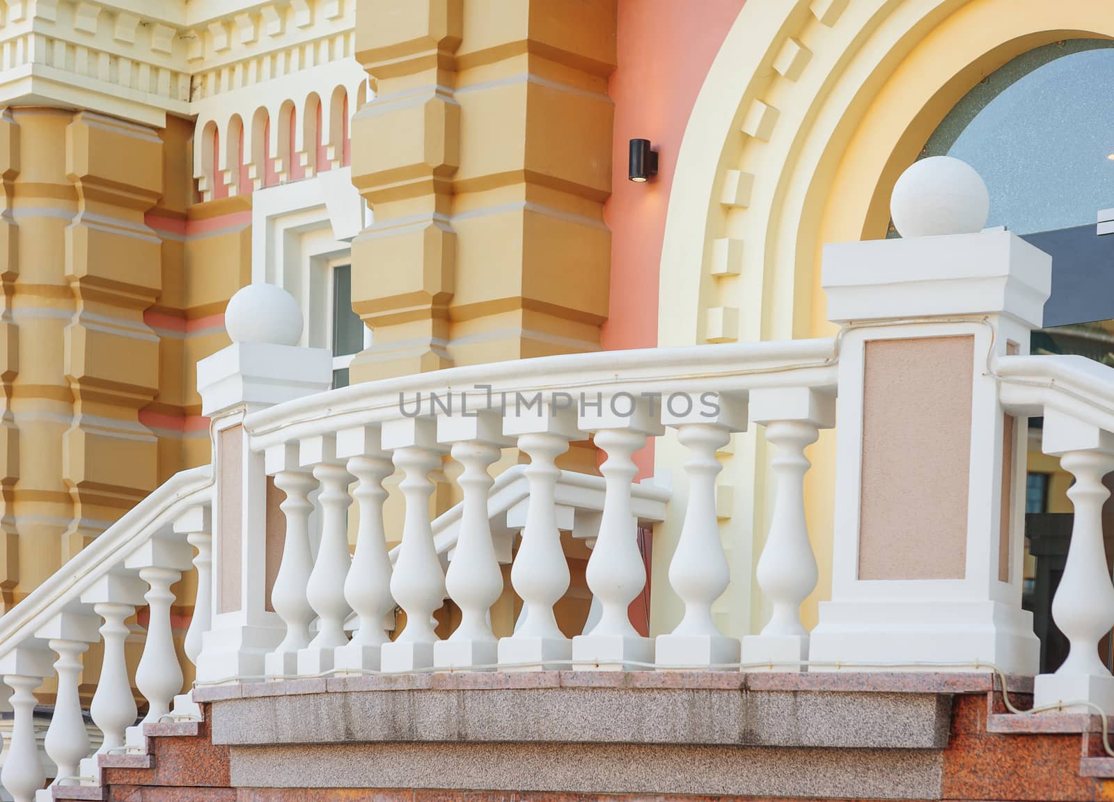 part of old architectural buildings with white balcony balustrades by timonko