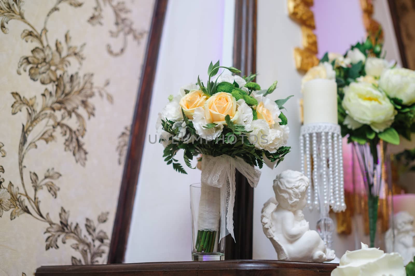 Beautiful bridal bouquet of white and yellow flowers in the interior.