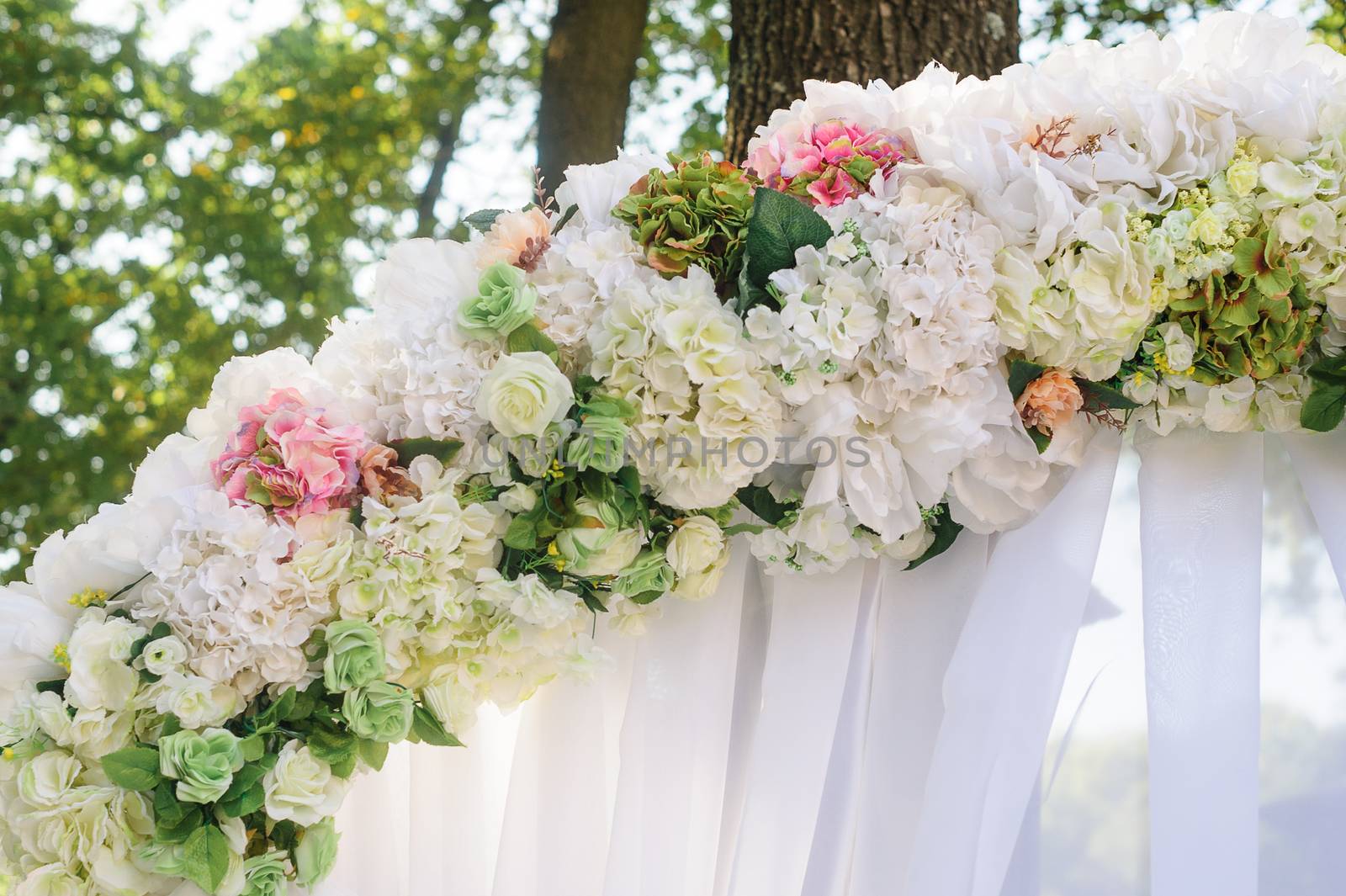 Element wedding arches of white and pink flowers close-up by timonko