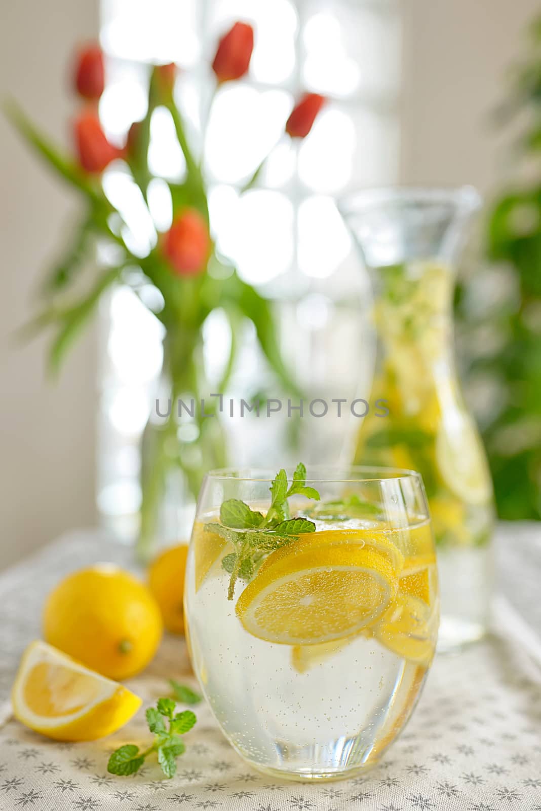 Fresh limes and lemonade on table