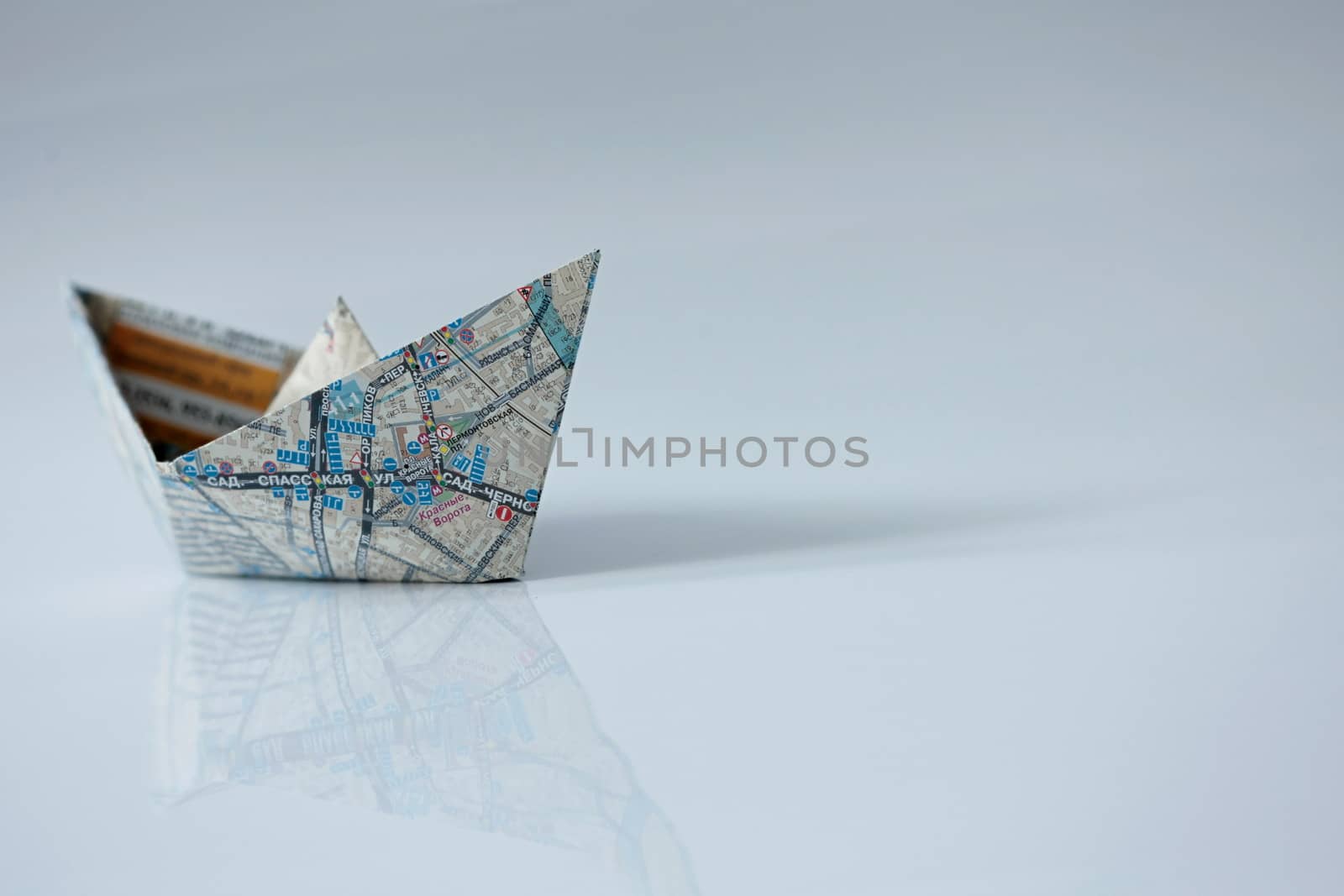 Paper ship on a white close to