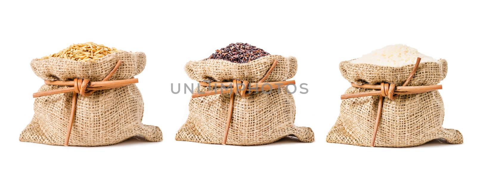 Different of jasmine rice, Paddy, brown and white rice in sack bag isolated on white background.