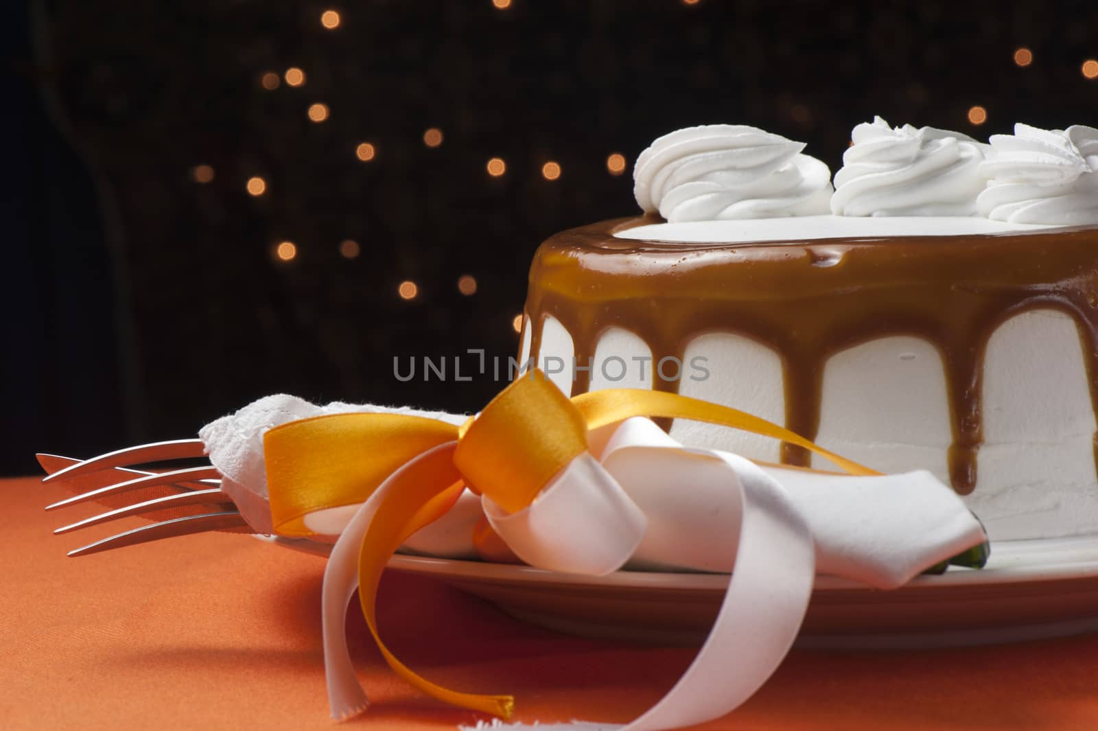 a cake covered with whipped cream and chocolate seals