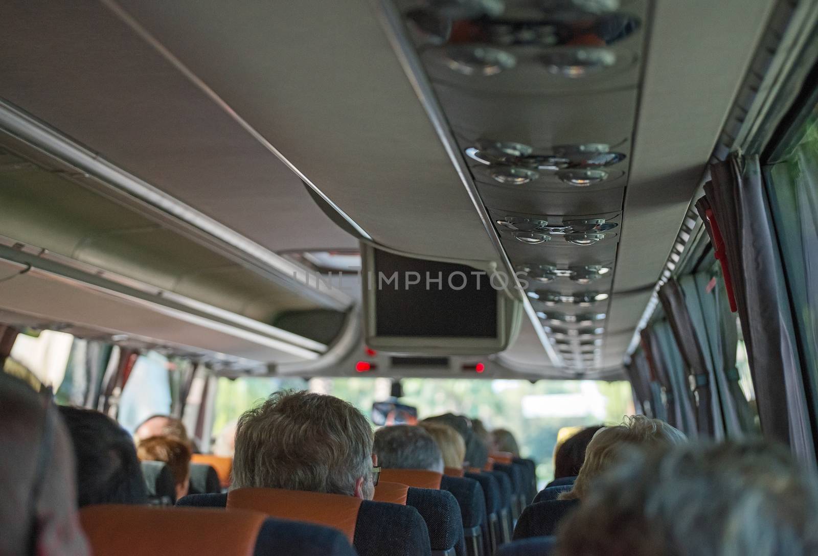 View from inside the bus with passengers. by dmitrimaruta