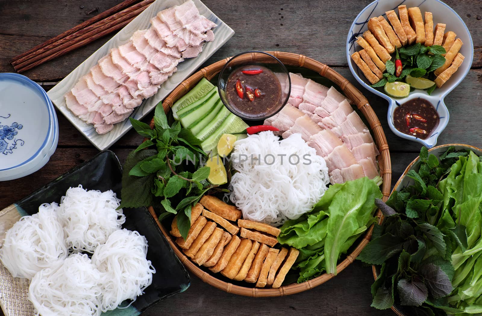 Delicious Vietnamese food, bun dau mam tom, is popular street food make from vermicelli with boiled meat, fried tofu, shrimp paste and green vegetables, cucumer and spice as chilli, lemon 