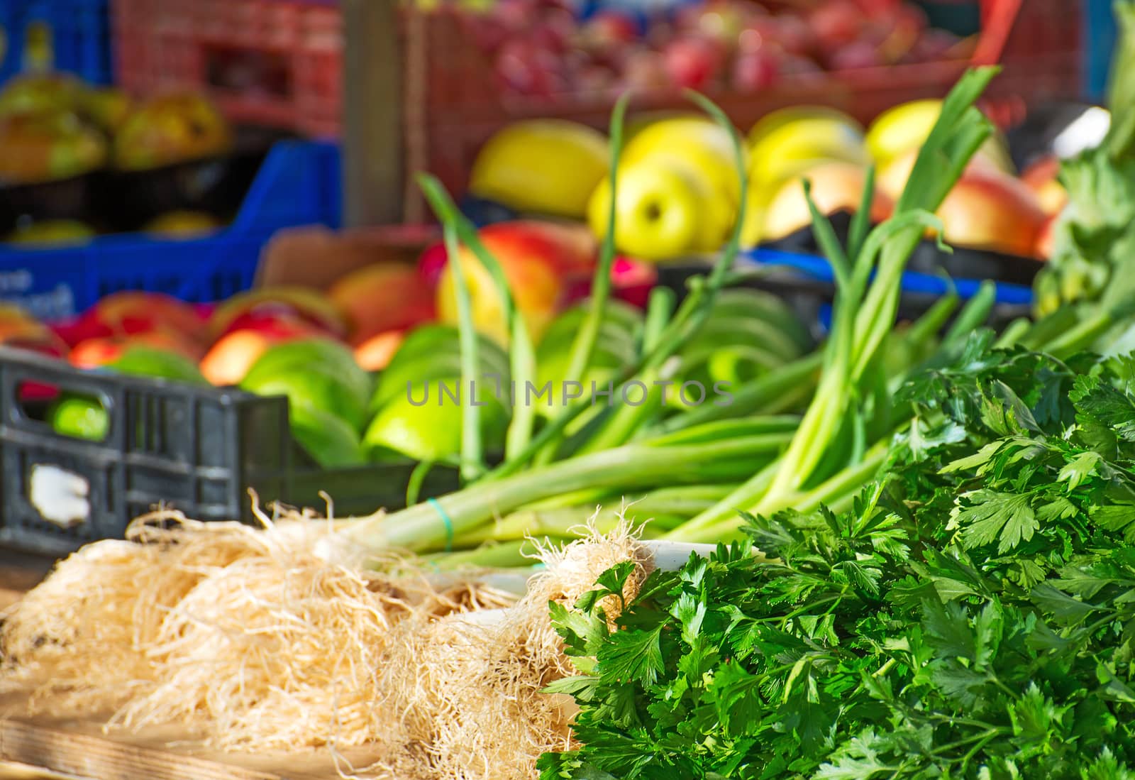 Onion, parsley and fruits on the market.