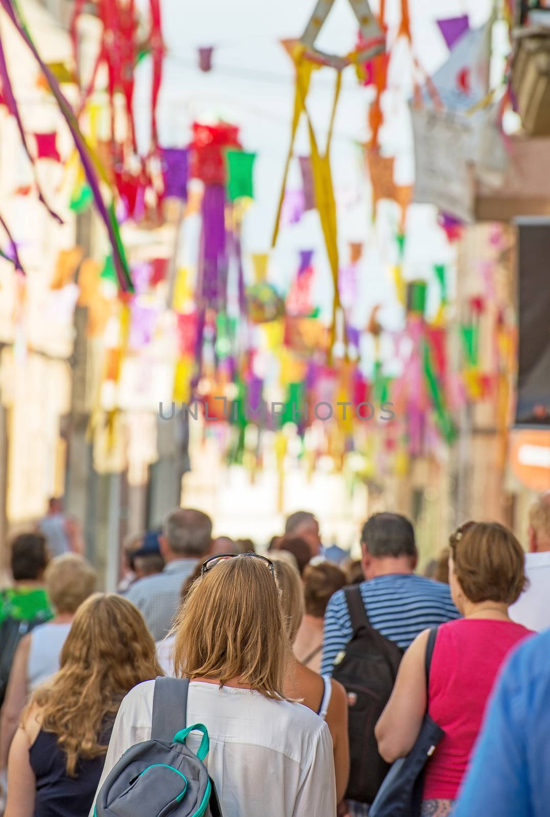 People walking during festival on the street.