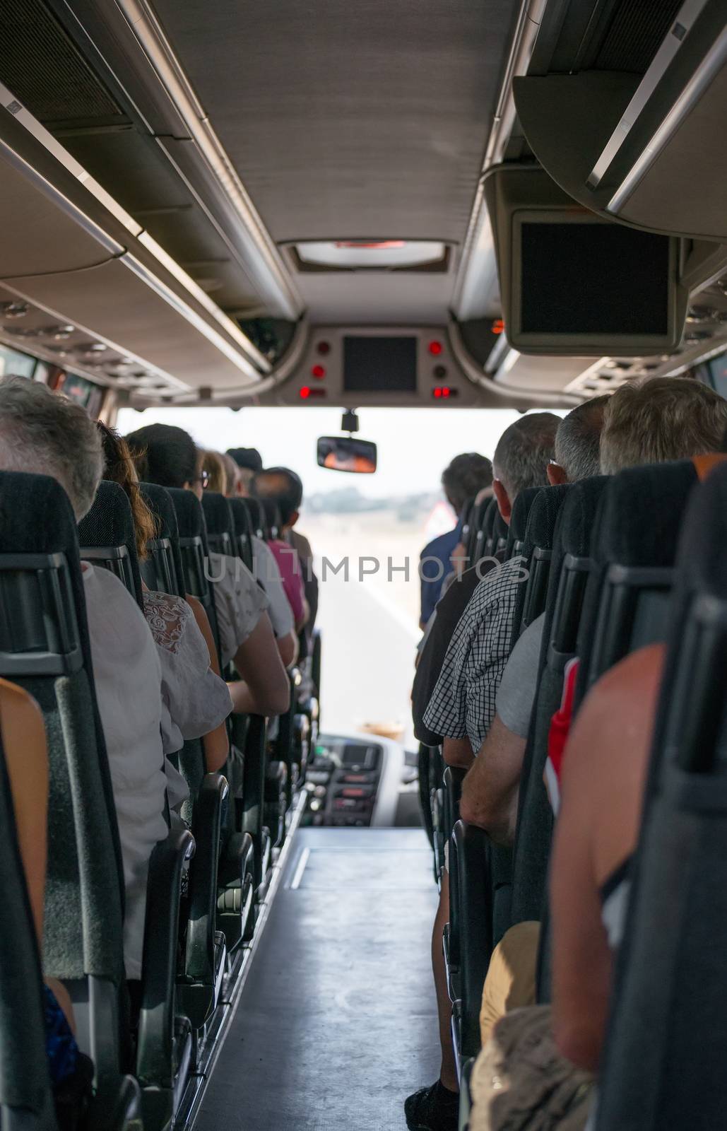 View from inside the bus with passengers.