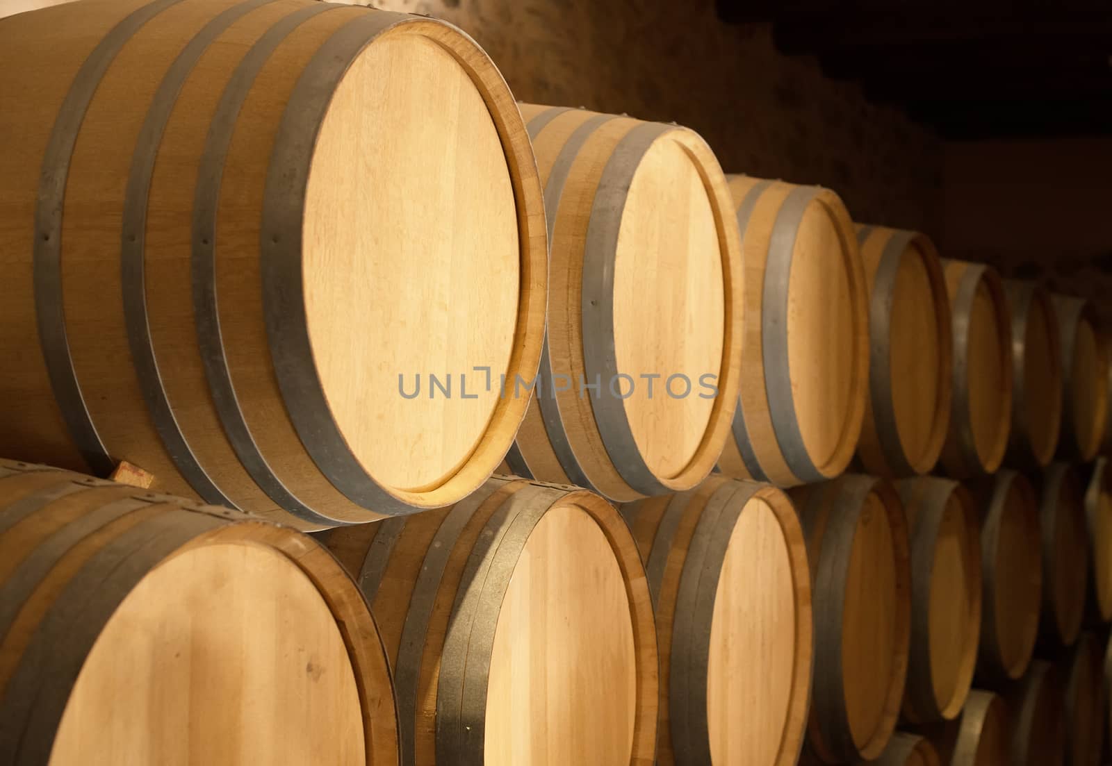 Wine barrels stacked in the cellar. by dmitrimaruta