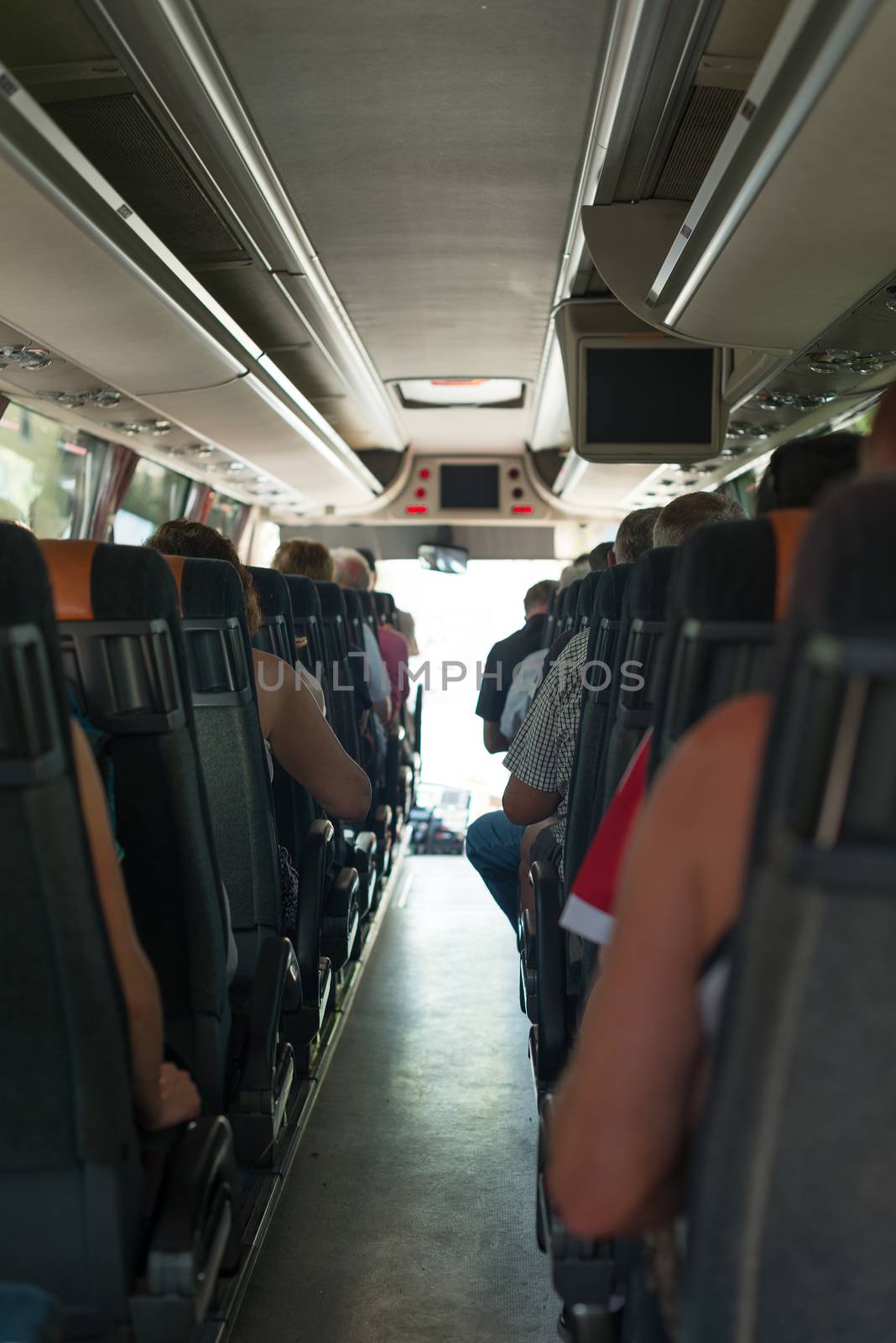 View from inside the bus with passengers. by dmitrimaruta