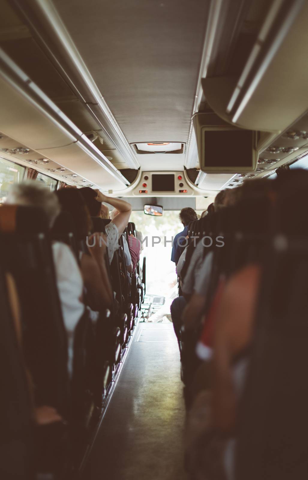 View from inside the bus with passengers. by dmitrimaruta
