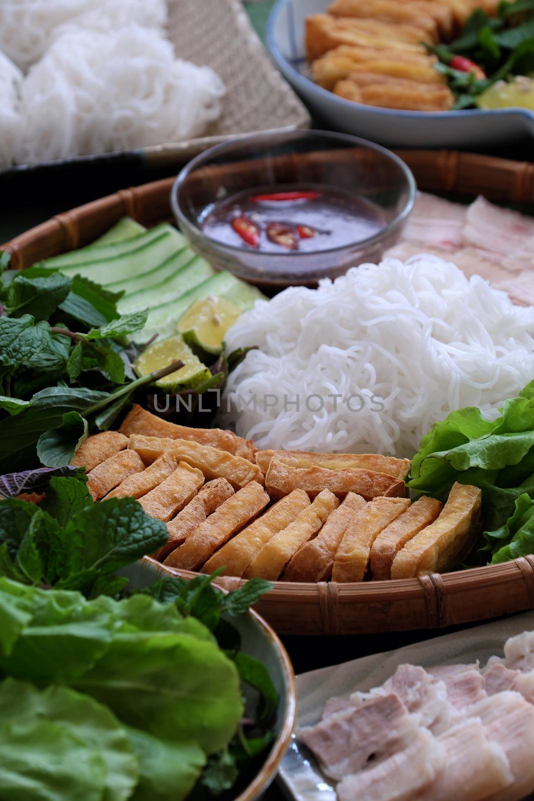 Delicious Vietnamese food, bun dau mam tom, is popular street food make from vermicelli with boiled meat, fried tofu, shrimp paste and green vegetables, cucumer and spice as chilli, lemon 