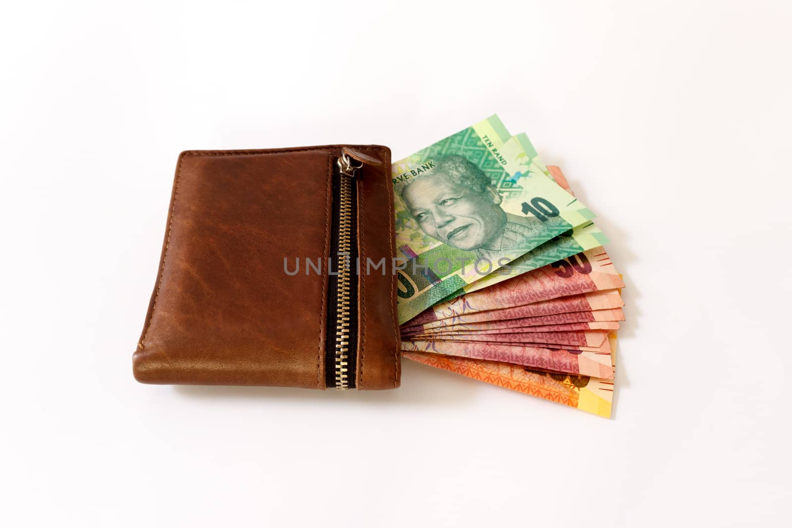 South African Rand in wallet sticking outoff a wallet on a white canvas