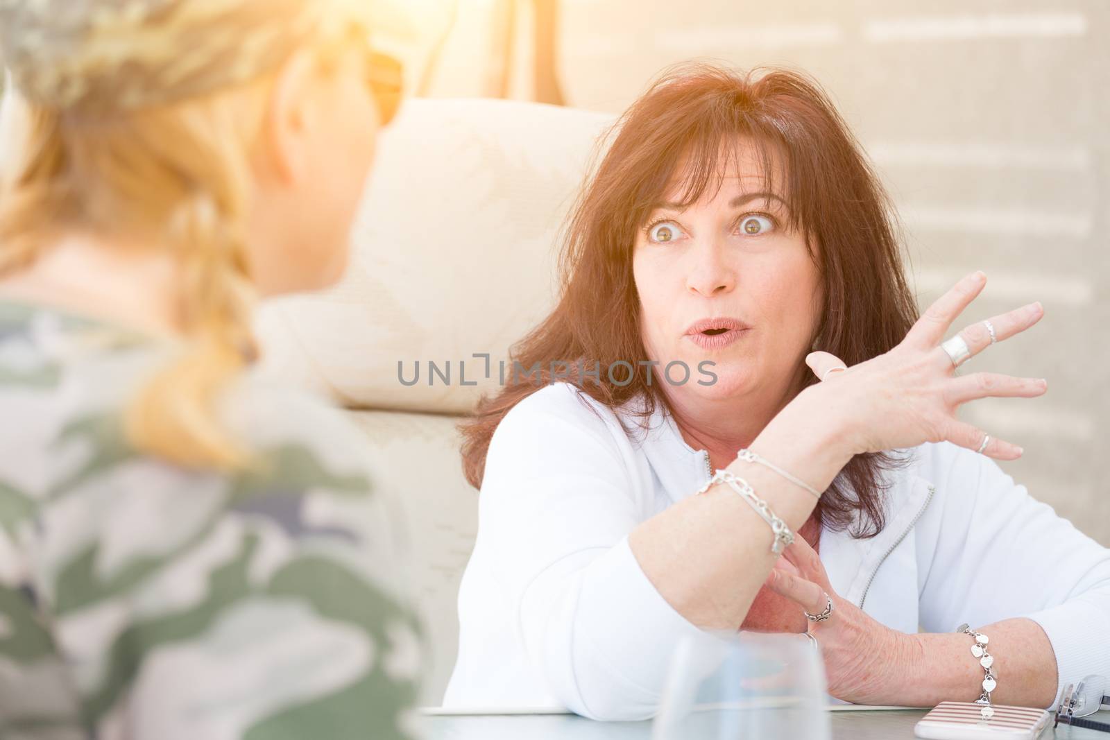 Two Female Friends Enjoying Conversation Outside by Feverpitched