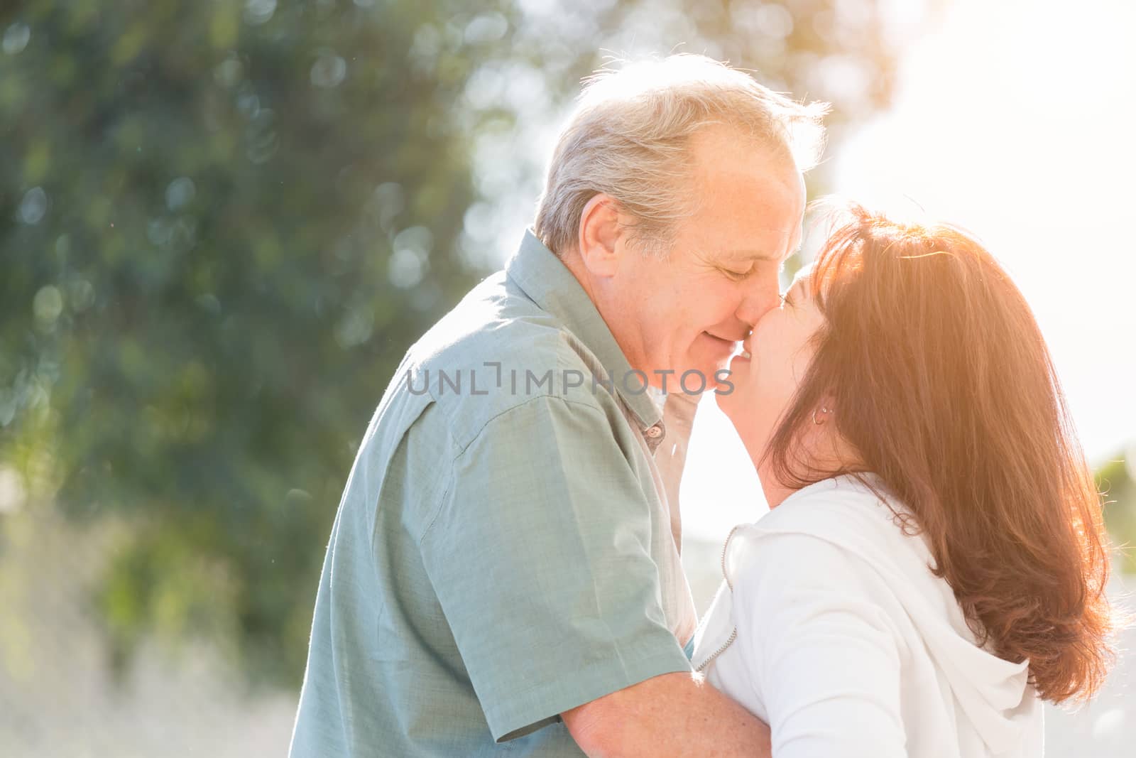 Middle Aged Couple Enjoy A Romantic Slow Dance and Kiss Outside by Feverpitched