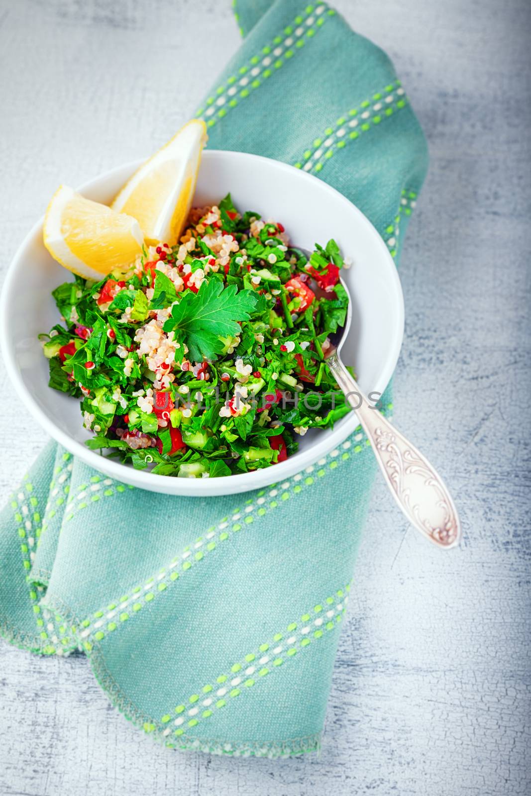 Quinoa tabbouleh salad on a wooden table.
