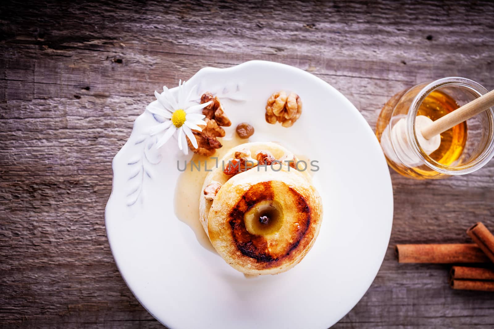 Baked apple with nuts and raisins on a table