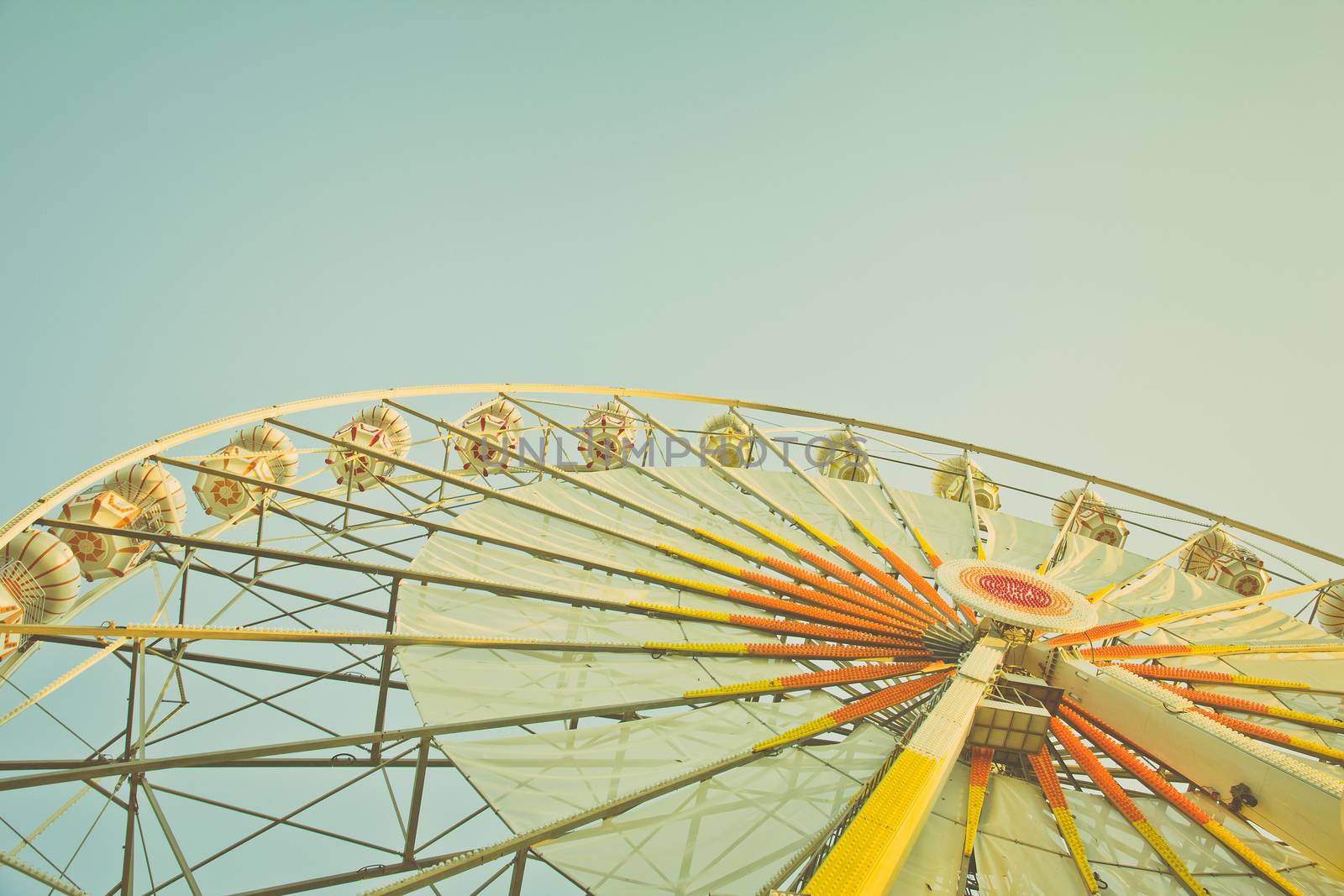 ferris wheel against a blue sky in vintage style