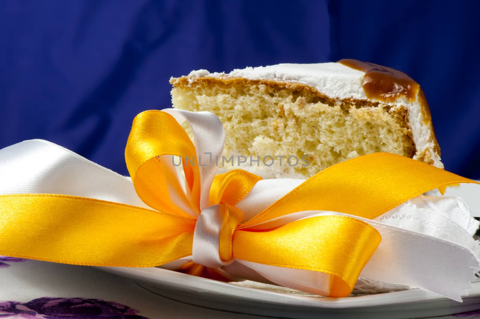 a cake covered with whipped cream and chocolate seals