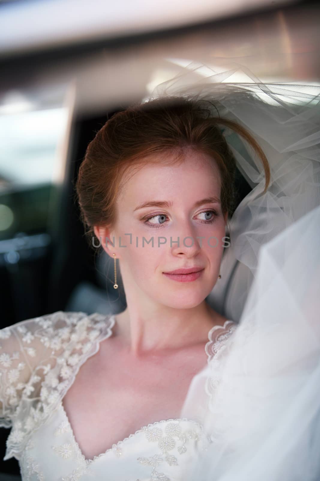 Portrait of a beautiful bride in a car
