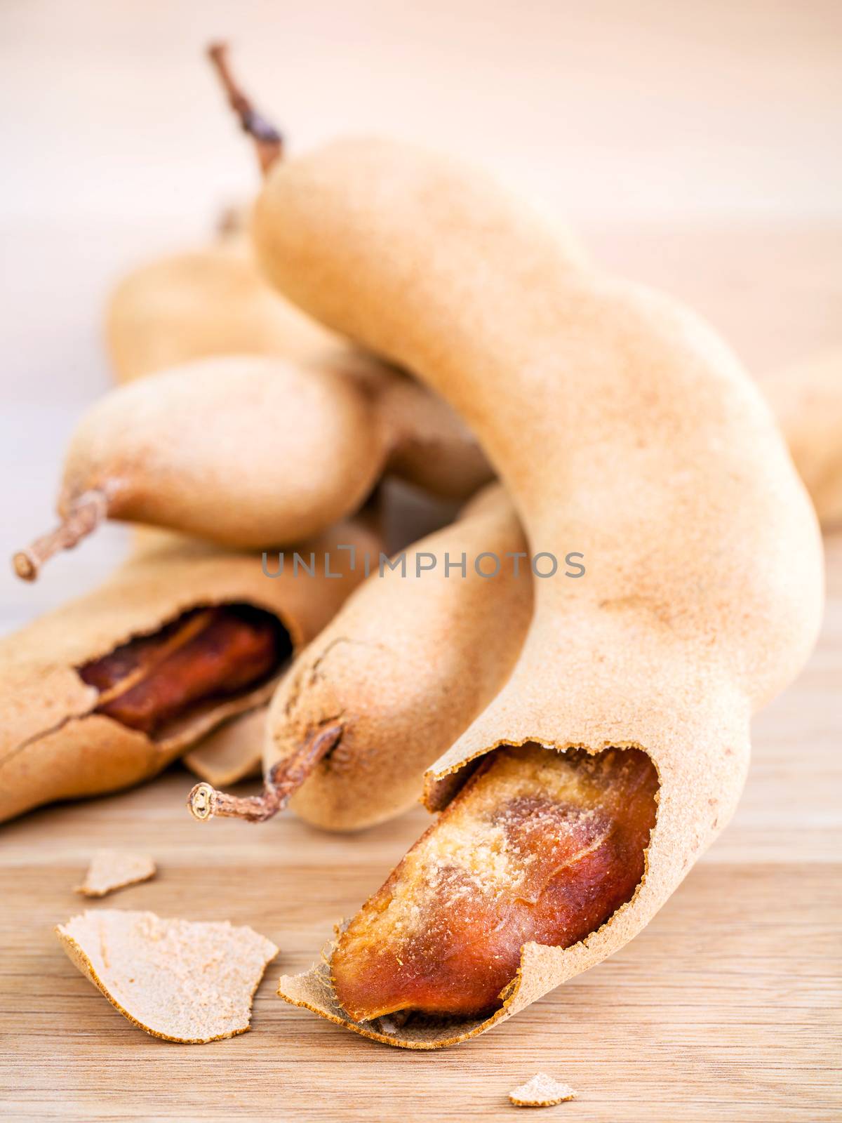 Close up tamarind for homemade skin care and body scrub  set up on wooden background.
