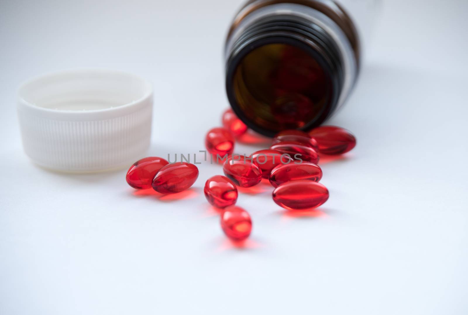 Tabs Vitamins, omega 3, Medications tablets and capsules in a beaker. Medications tablets, suppository bottles, capsules and thermometer on wooden table