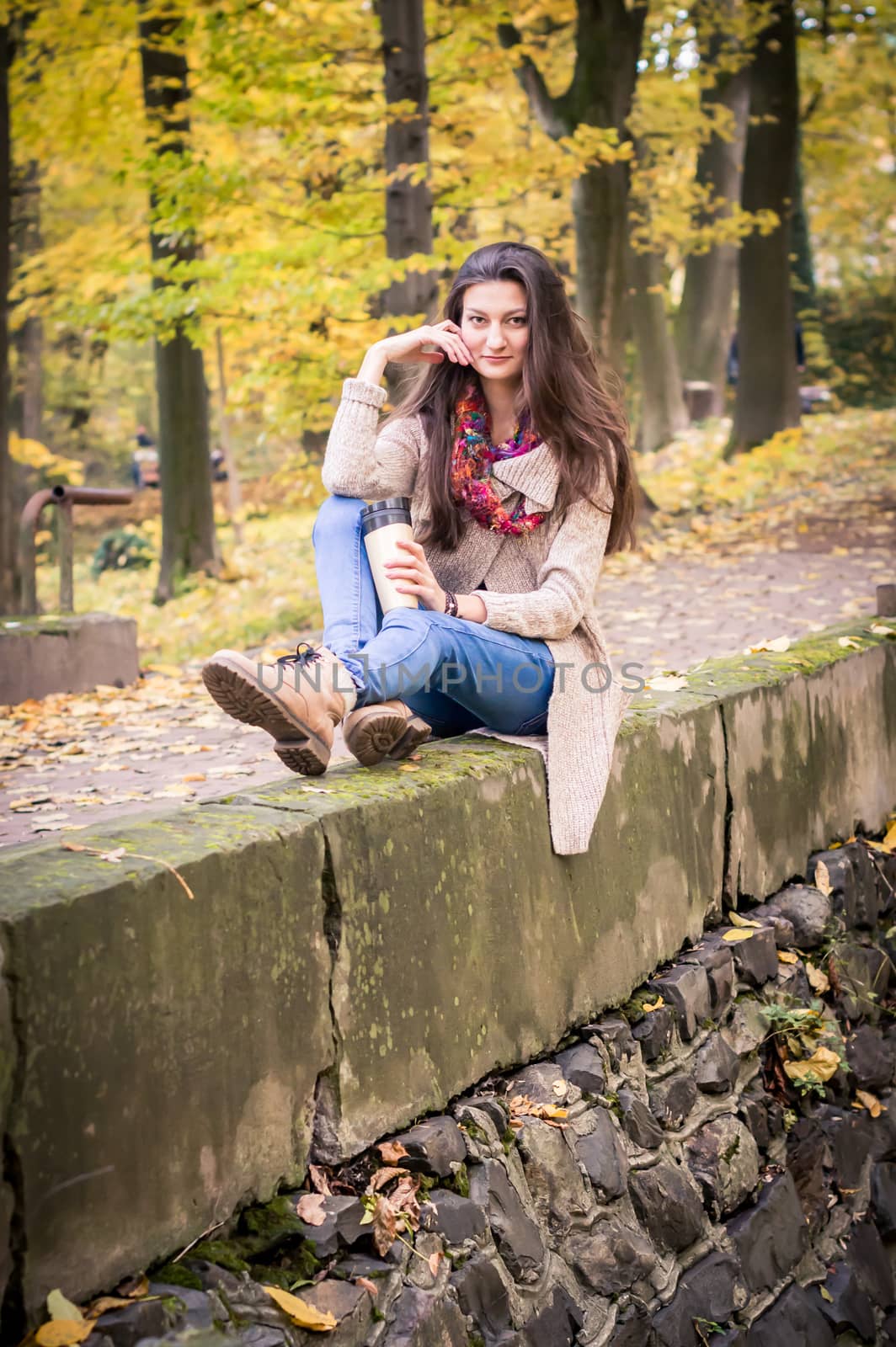 girl sitting on the concrete stone in the Park