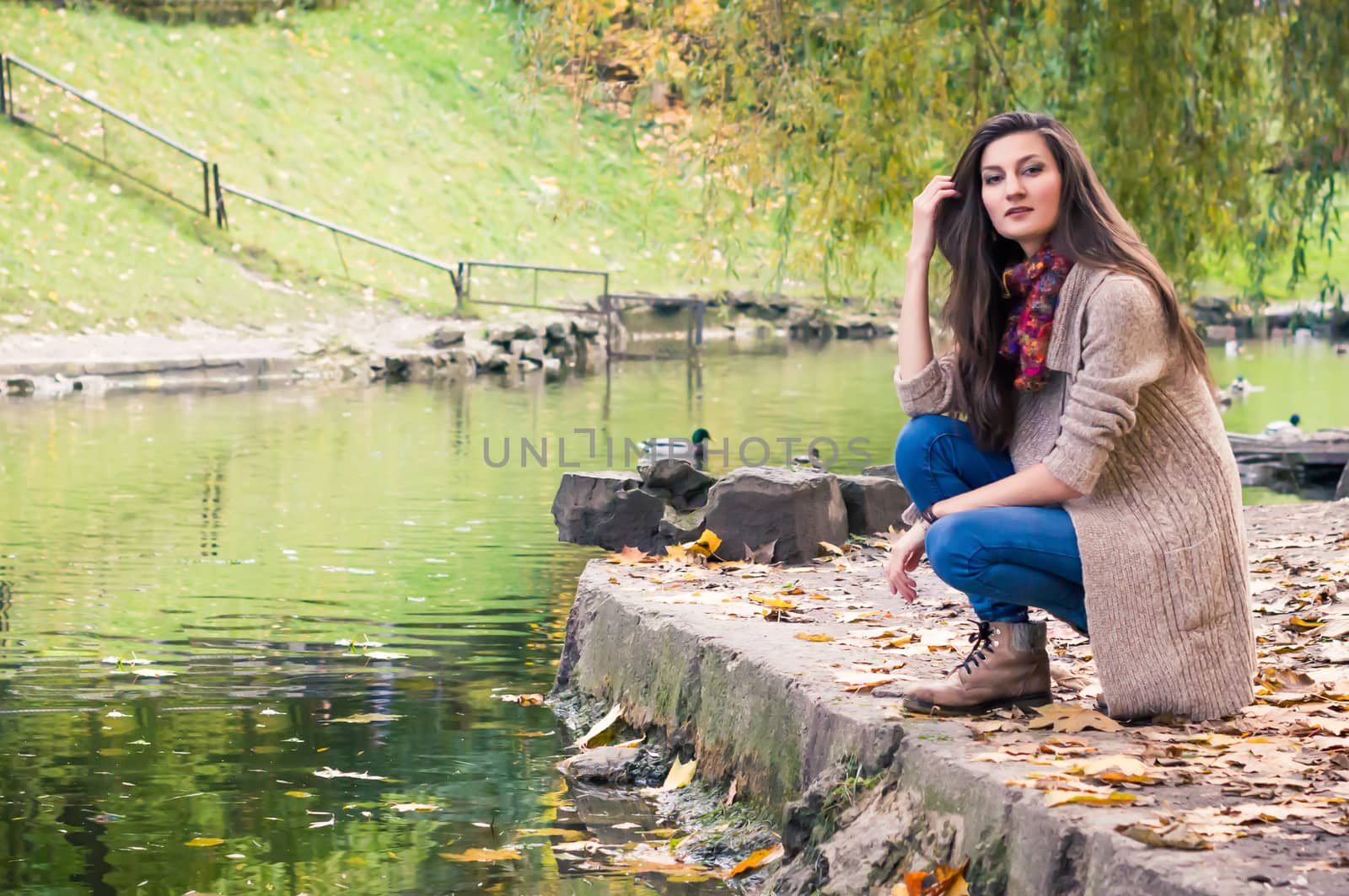 girl by the pond in autumn Park