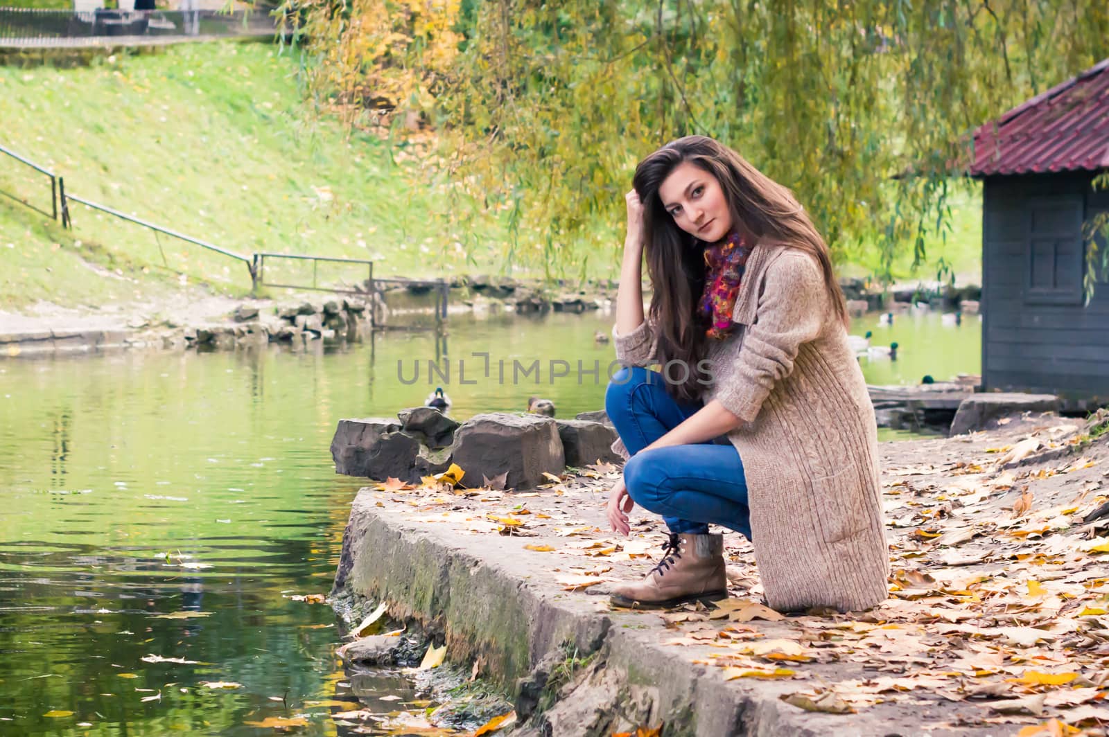 girl by the pond in autumn Park