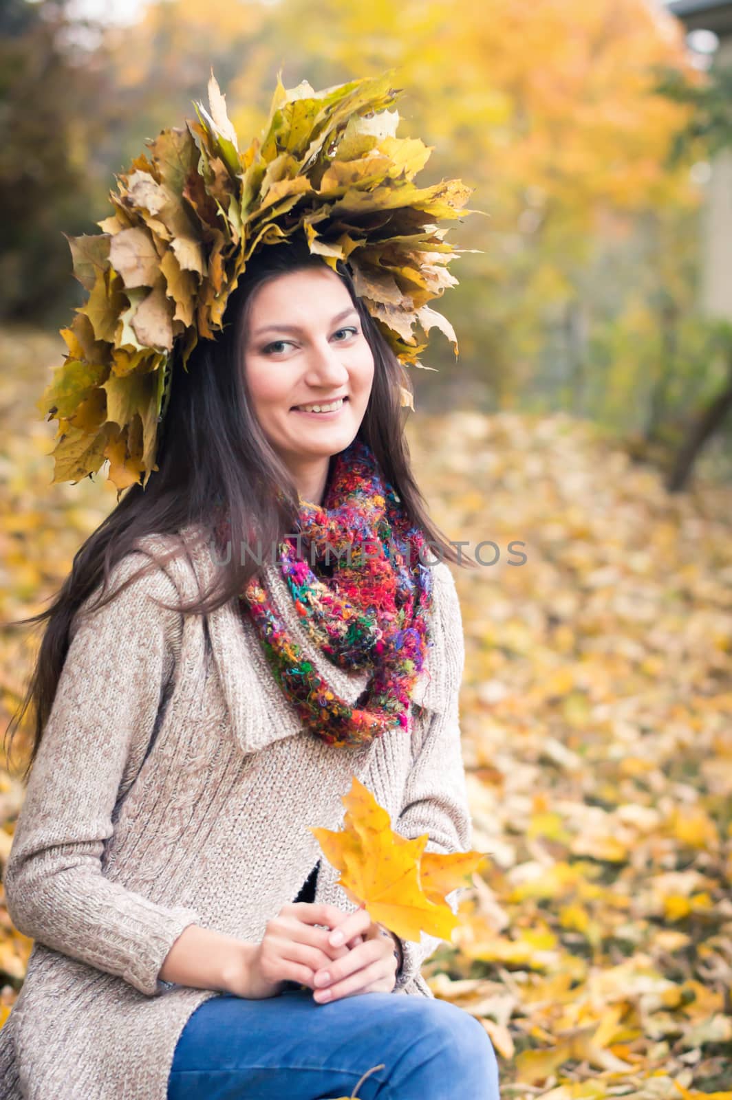 girl with a wreath of leaves in autumn Park