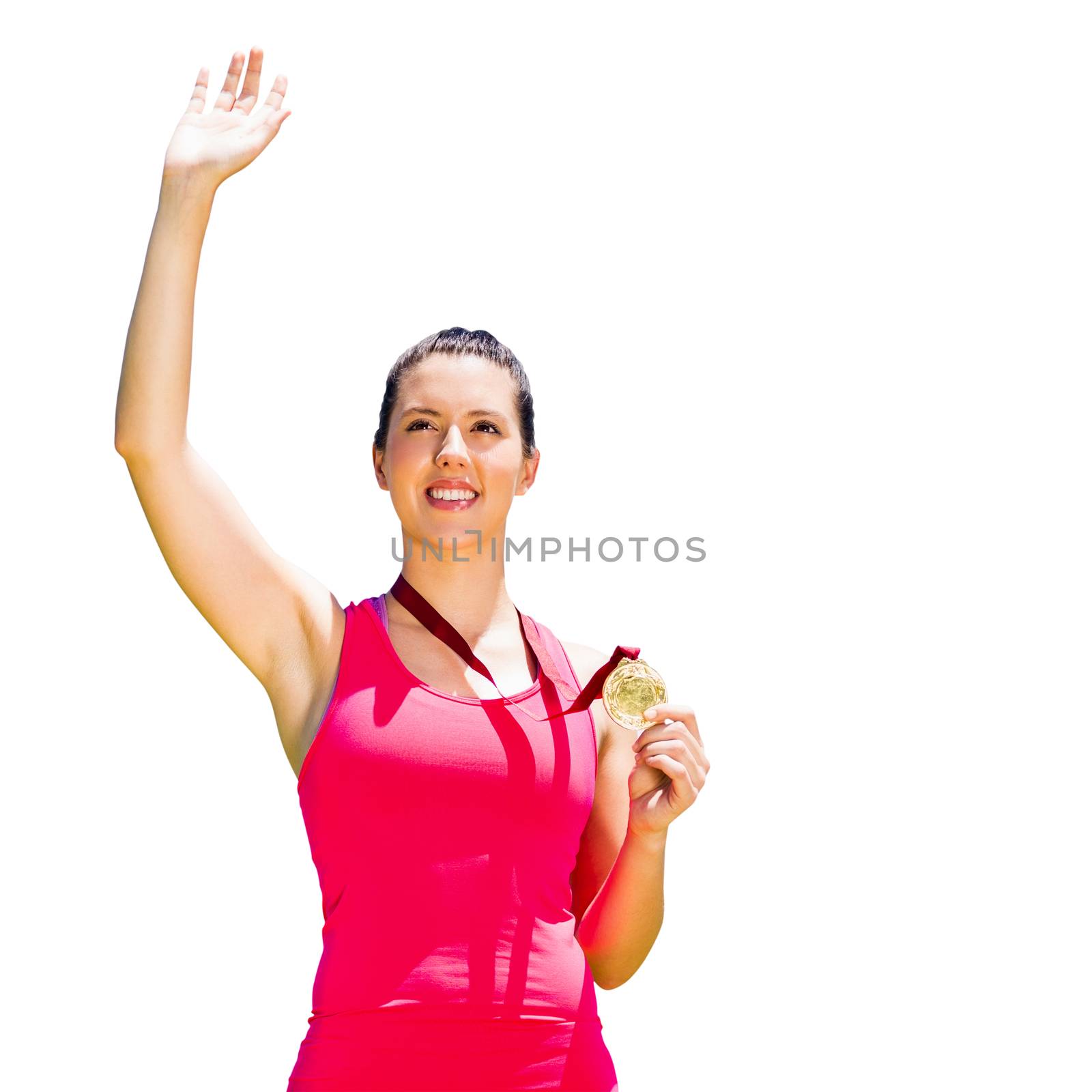 Athletic woman smiling and holding a medal against white background