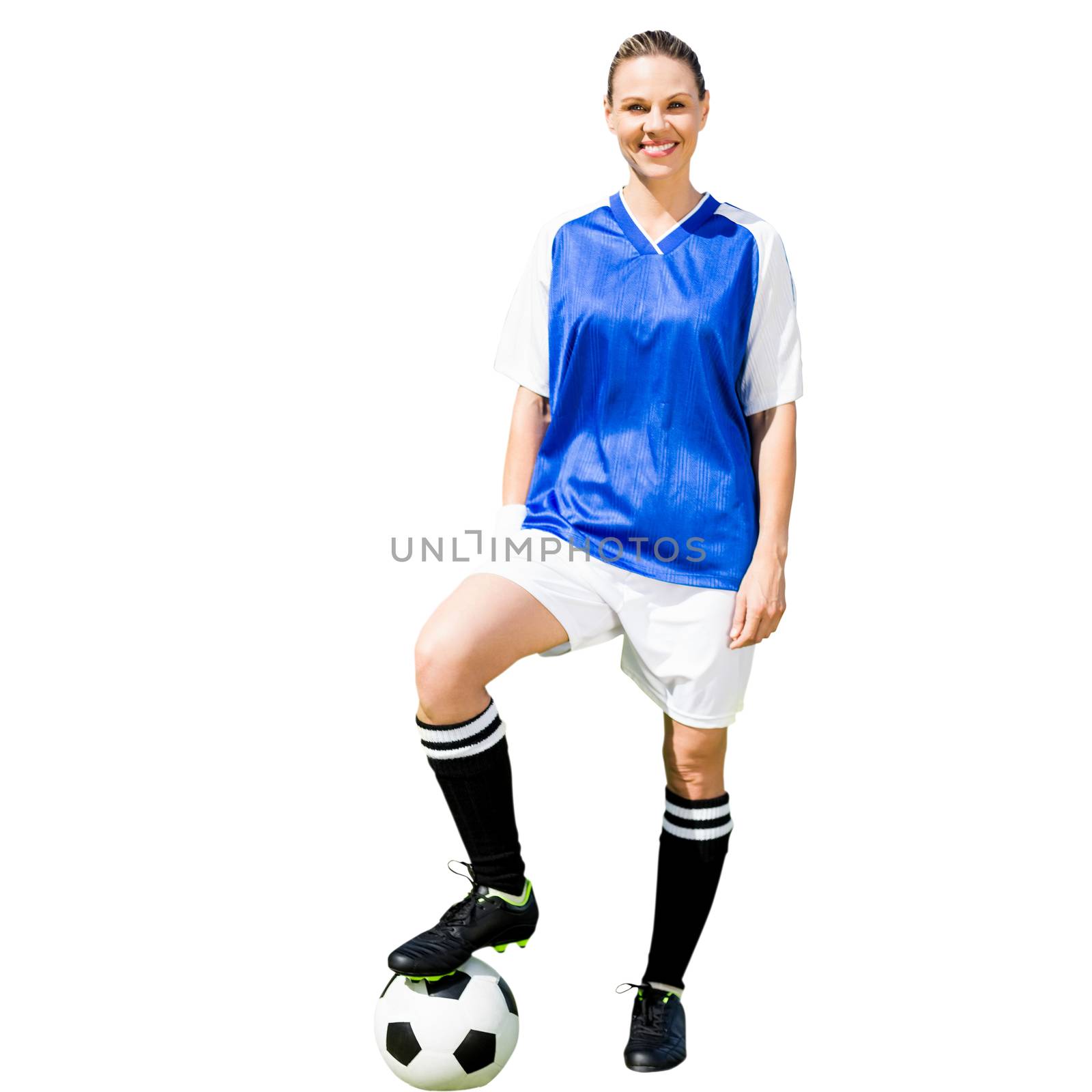 Woman soccer player smiling and posing with a ball in a white background 