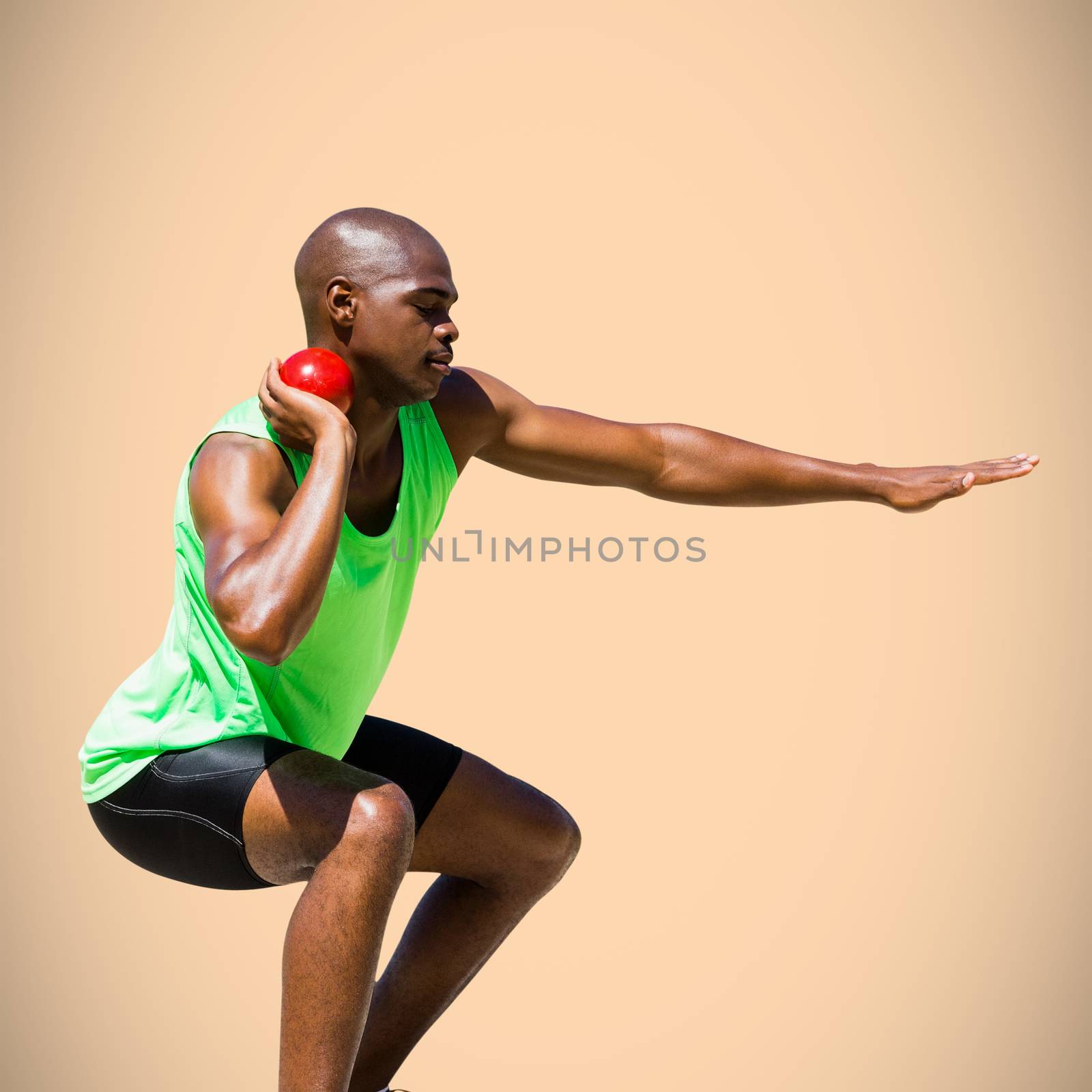 Sportsman practising the shot put against orange background