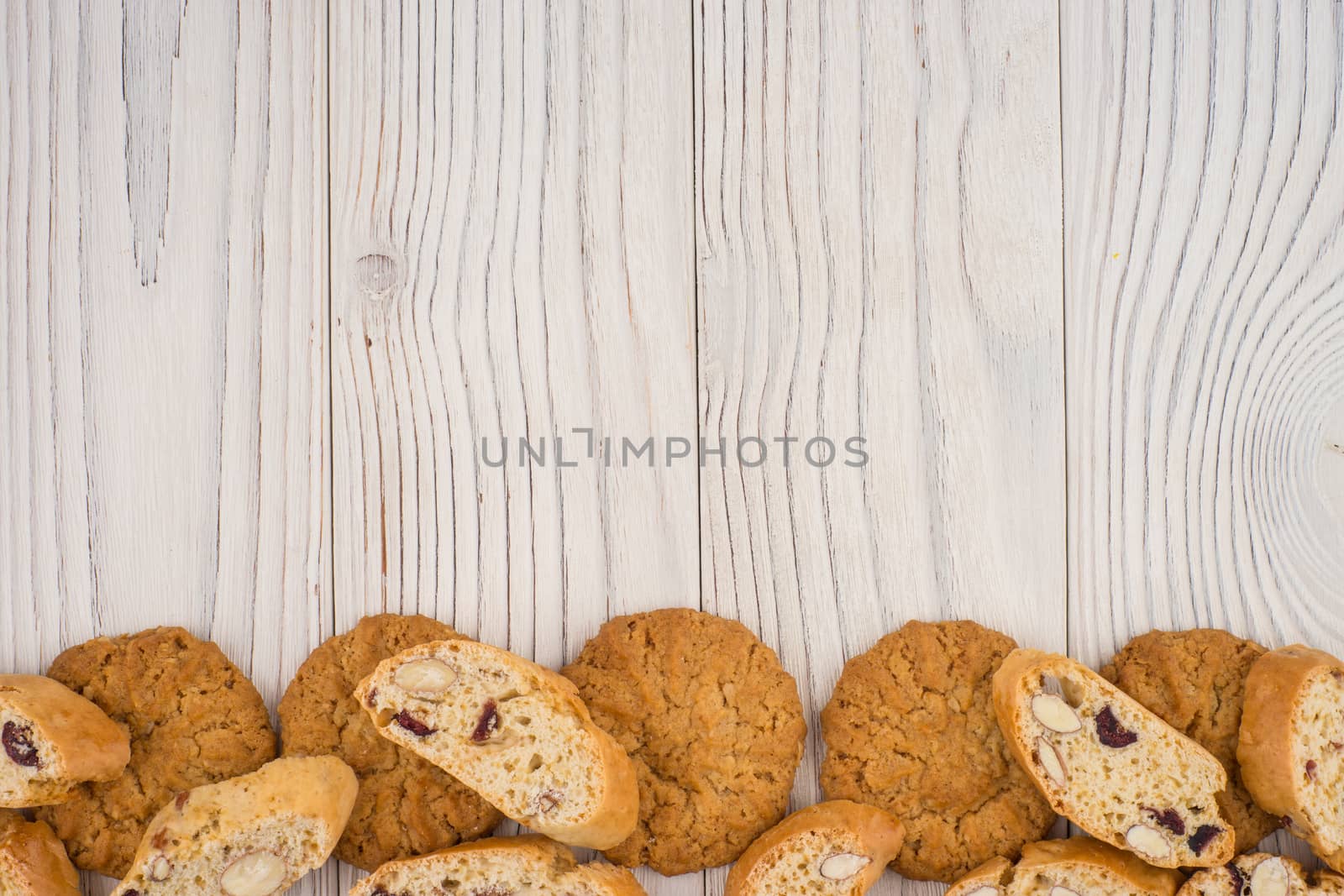 Different cookies on an old white wooden table. by DGolbay