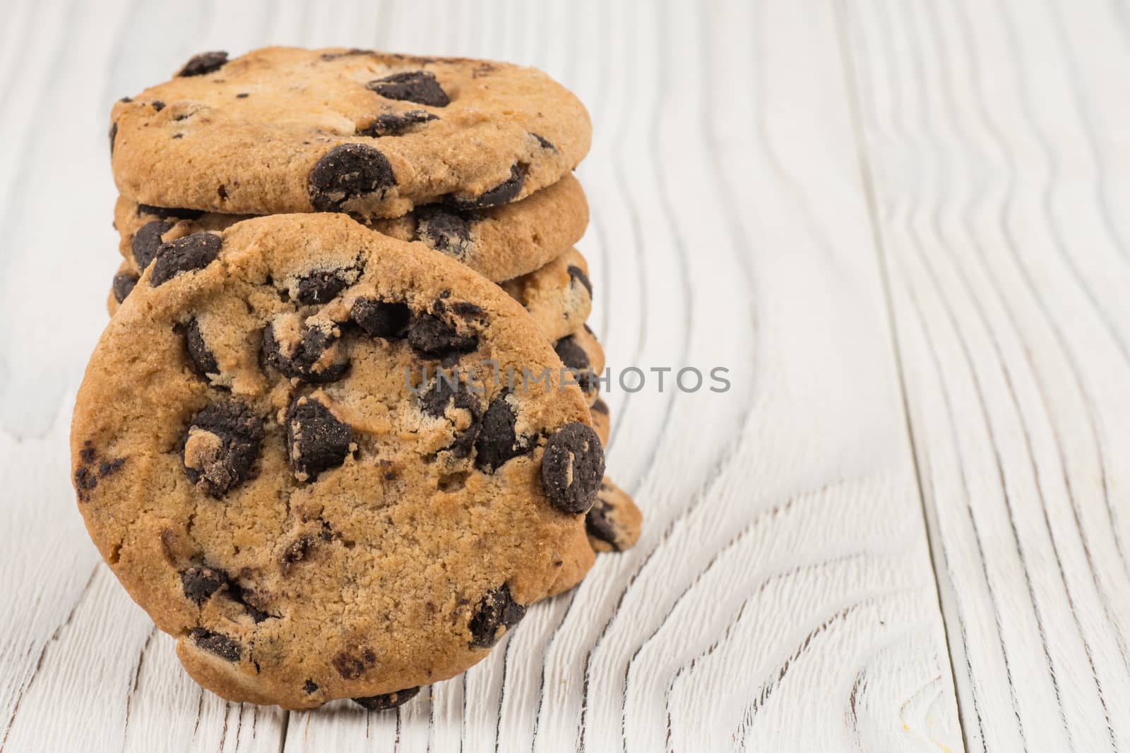 Chocolate cookies closeup on white old wooden table.  by DGolbay