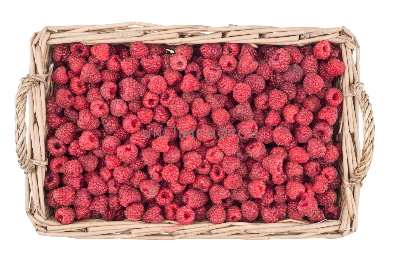 Raspberries in the basket isolated on white background. Top view.