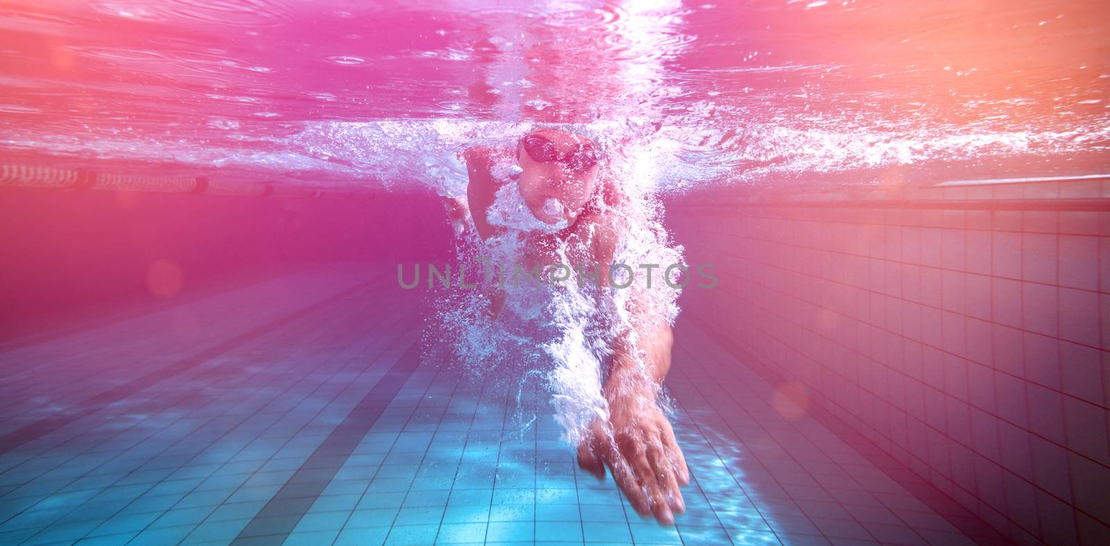Fit swimmer training by himself in the swimming pool at the leisure centre