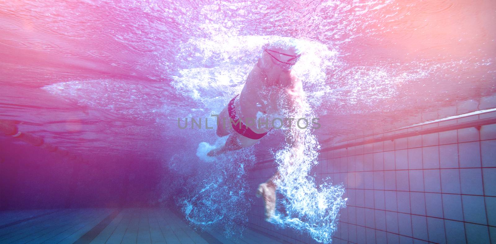 Fit swimmer training by himself in the swimming pool at the leisure centre