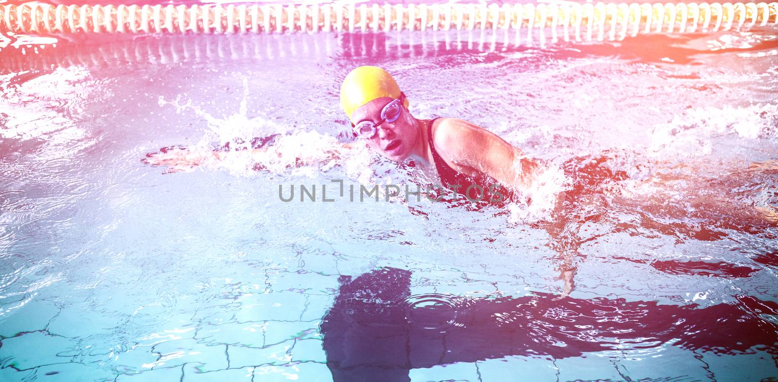 Side view of swimmer woman swimming in the swimming pool