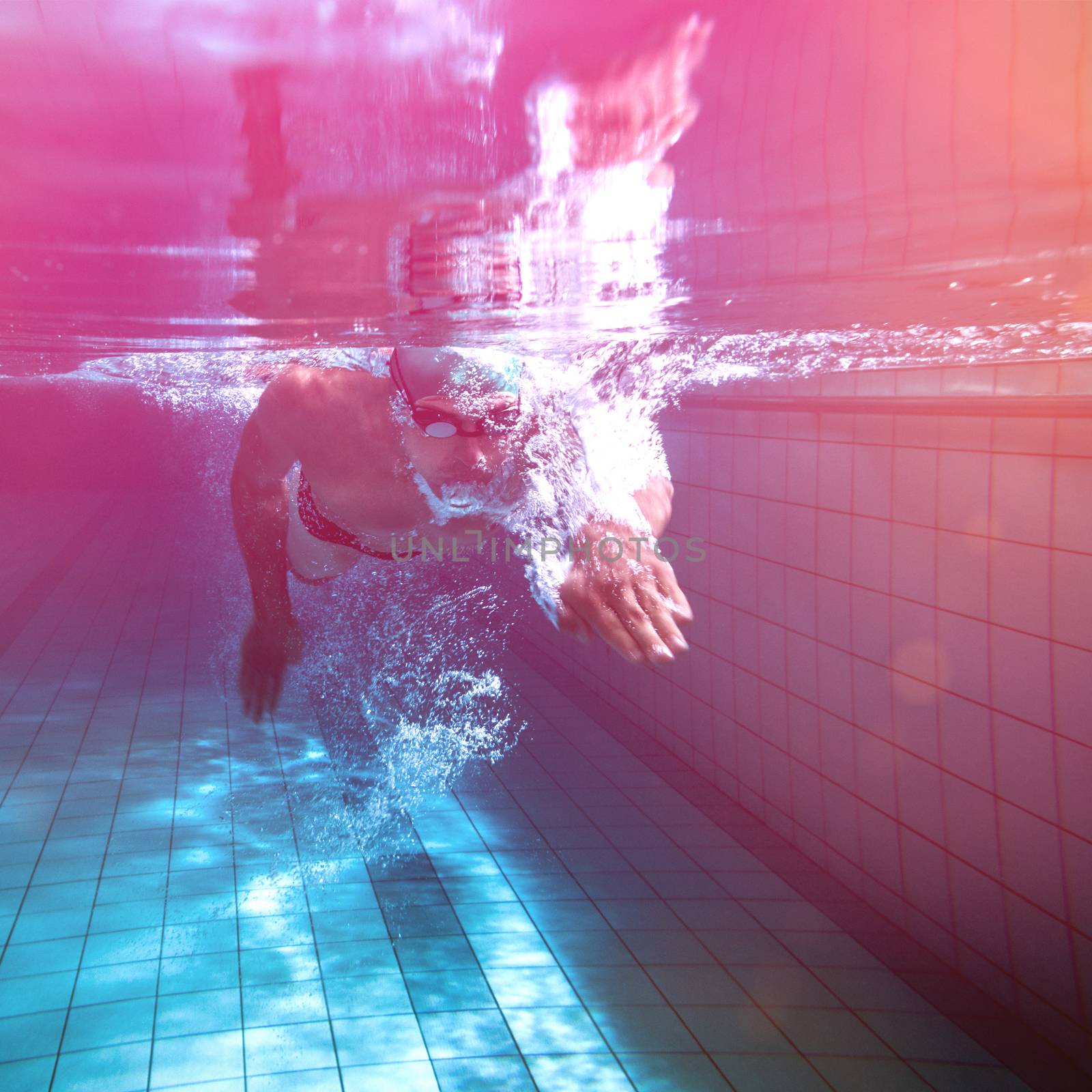 Fit swimmer training by himself in the swimming pool at the leisure centre