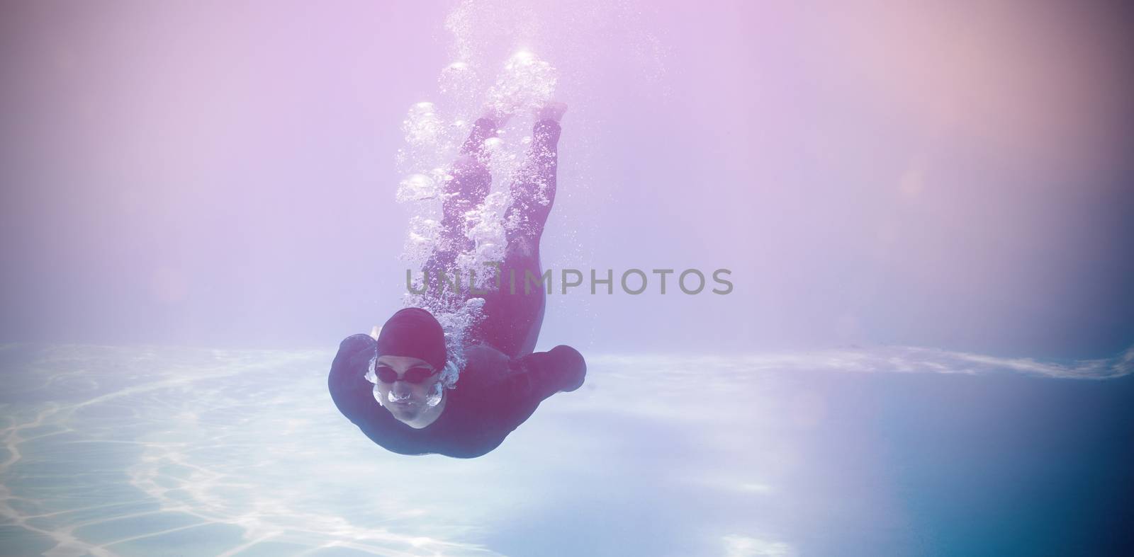Man wearing wetsuit while swimming underwater