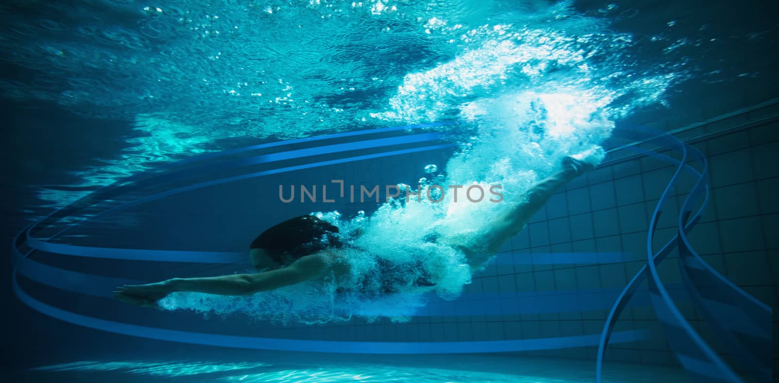 Athletic swimmer smiling at camera underwater against feet of woman standing on the edge of the pool