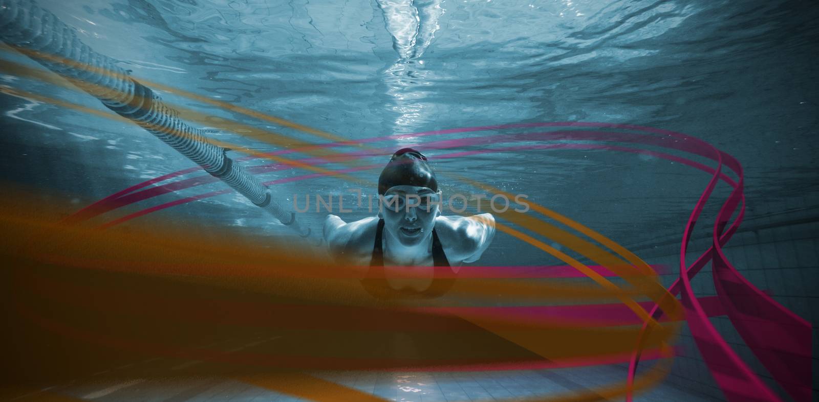 Athletic swimmer training on her own against feet of woman standing on the edge of the pool