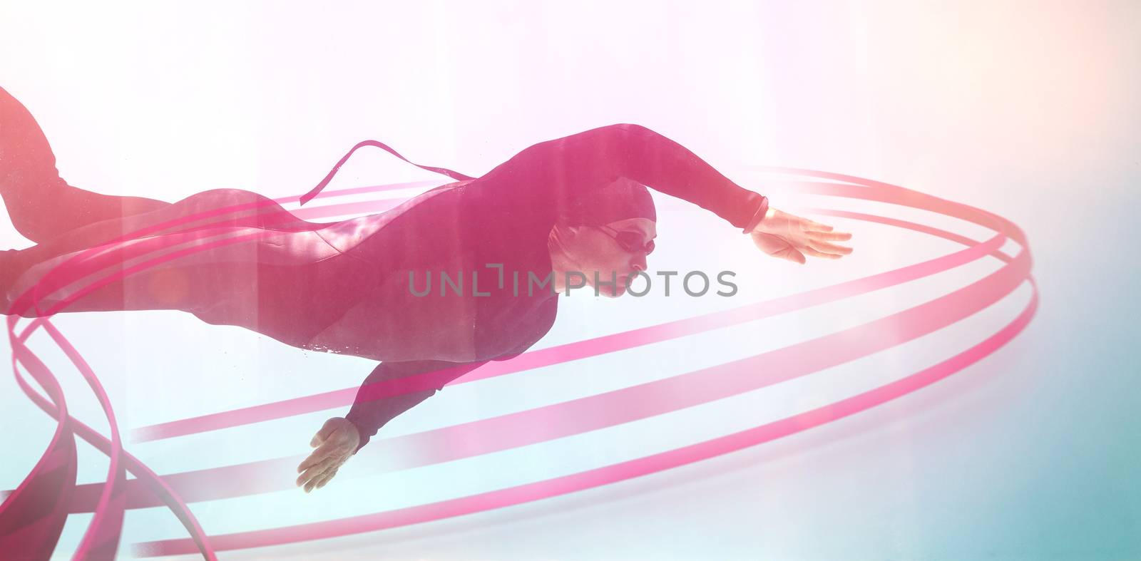 Young man with arm raised while swimming underwater