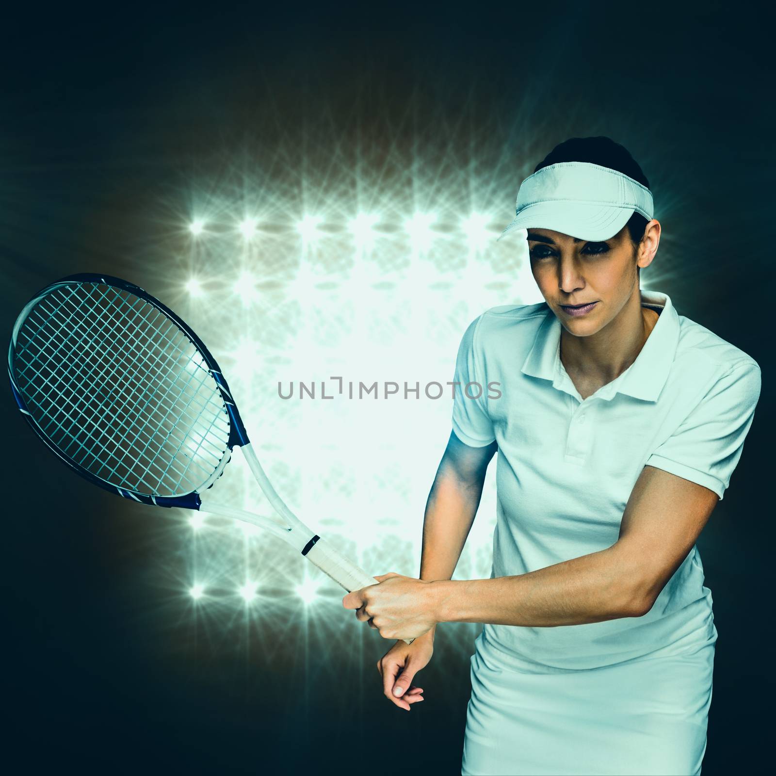 Female athlete playing tennis against spotlight