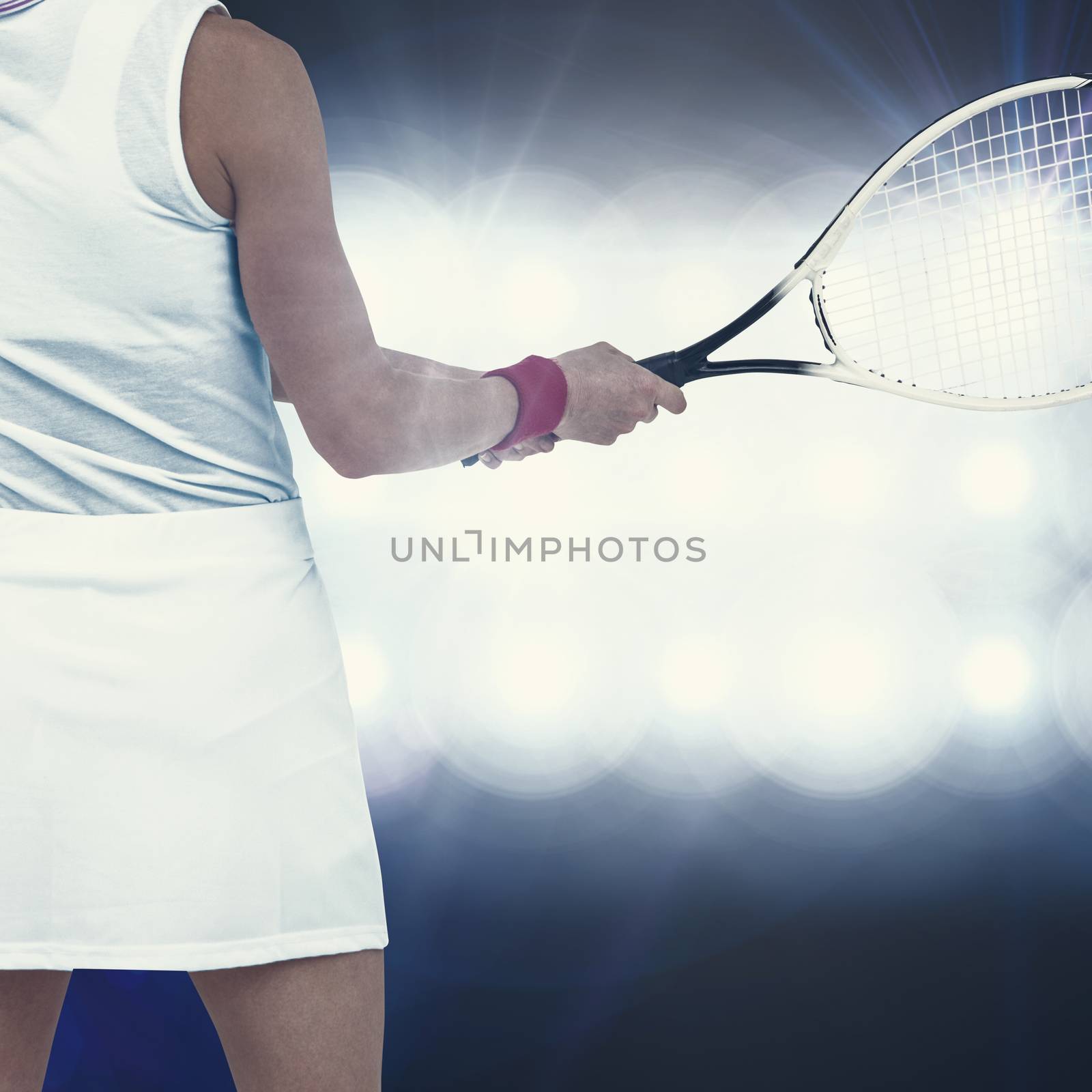 Athlete playing tennis with a racket  against spotlights